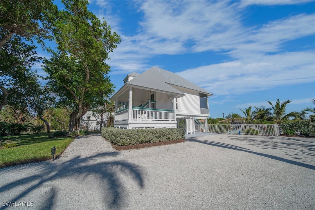 862 Beach Road Sanibel, FL 33957 - Photo 34 of 49 a front view of a house with a yard and garage