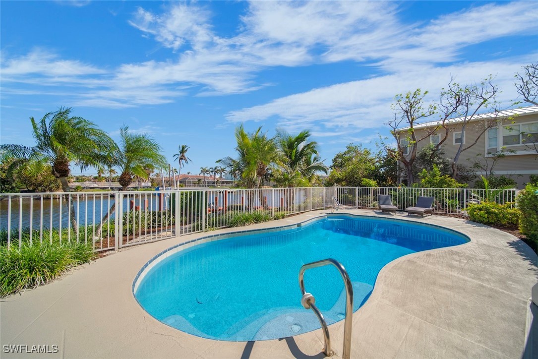 862 Beach Road Sanibel, FL 33957 - Photo 36 of 49 a view of a swimming pool with a lounge chair