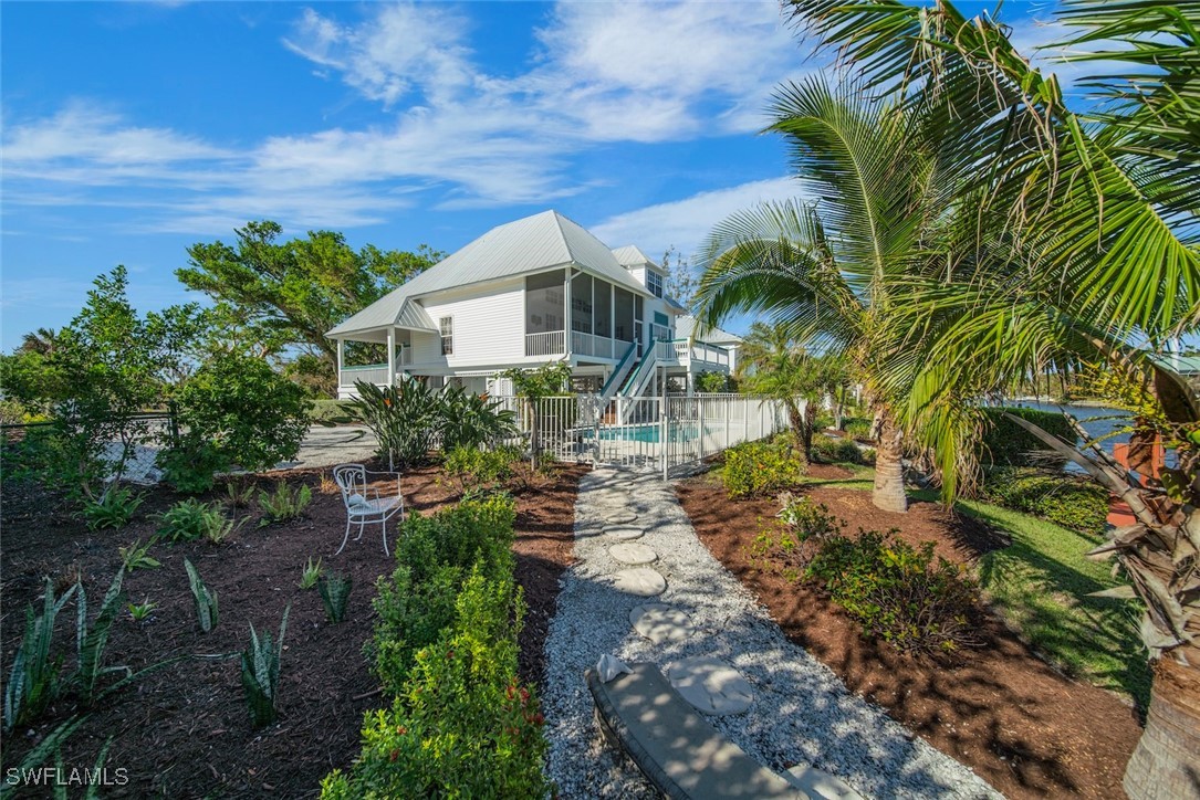 862 Beach Road Sanibel, FL 33957 - Photo 39 of 49 a front view of a house with a yard