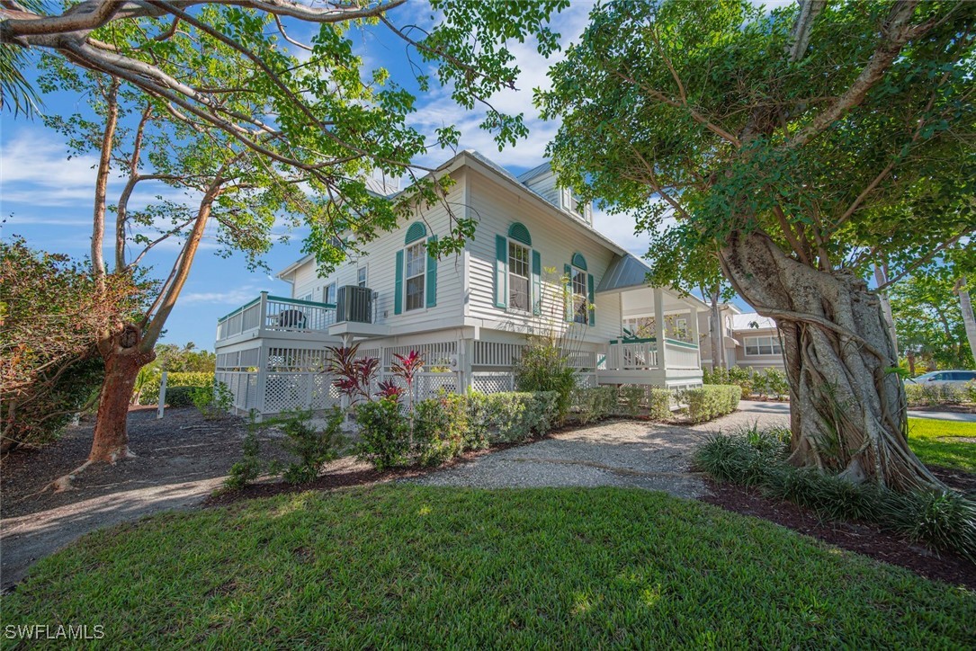 862 Beach Road Sanibel, FL 33957 - Photo 4 of 49 a front view of house with yard and green space