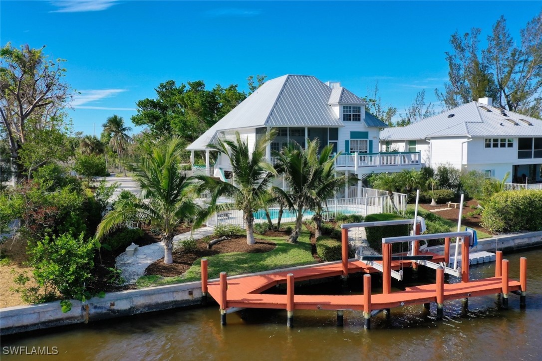 862 Beach Road Sanibel, FL 33957 - Photo 43 of 49 a view of swimming pool with outdoor seating and yard