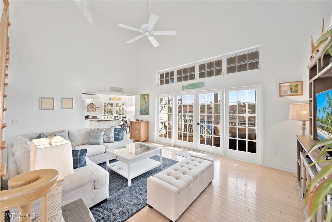 862 Beach Road Sanibel, FL 33957 - Photo 9 of 49 a living room with furniture a bookshelf and a flat screen tv