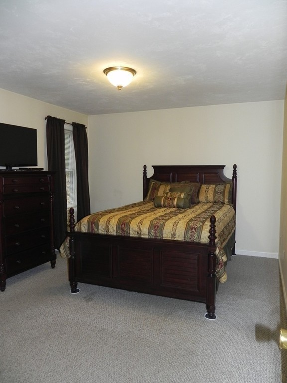 88 Brooks Road Athol, MA 01331 - Photo 17 of 30 a bed sitting in a bedroom next to a window