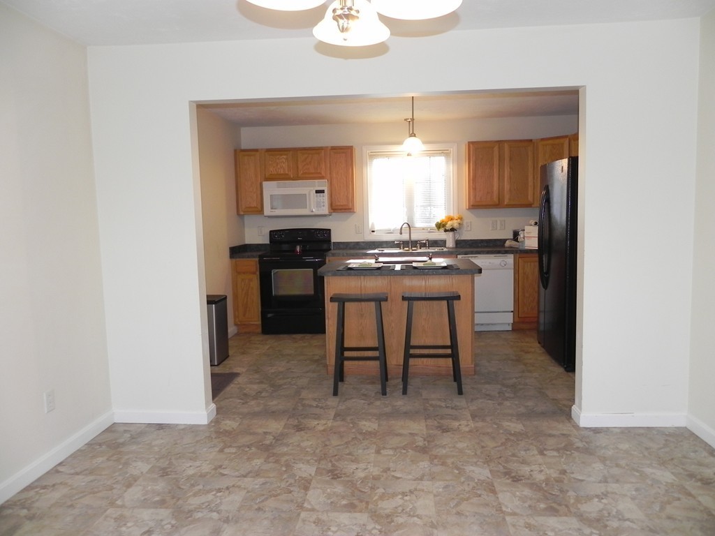 88 Brooks Road Athol, MA 01331 - Photo 7 of 30 a kitchen with stainless steel appliances granite countertop a stove a sink and a refrigerator