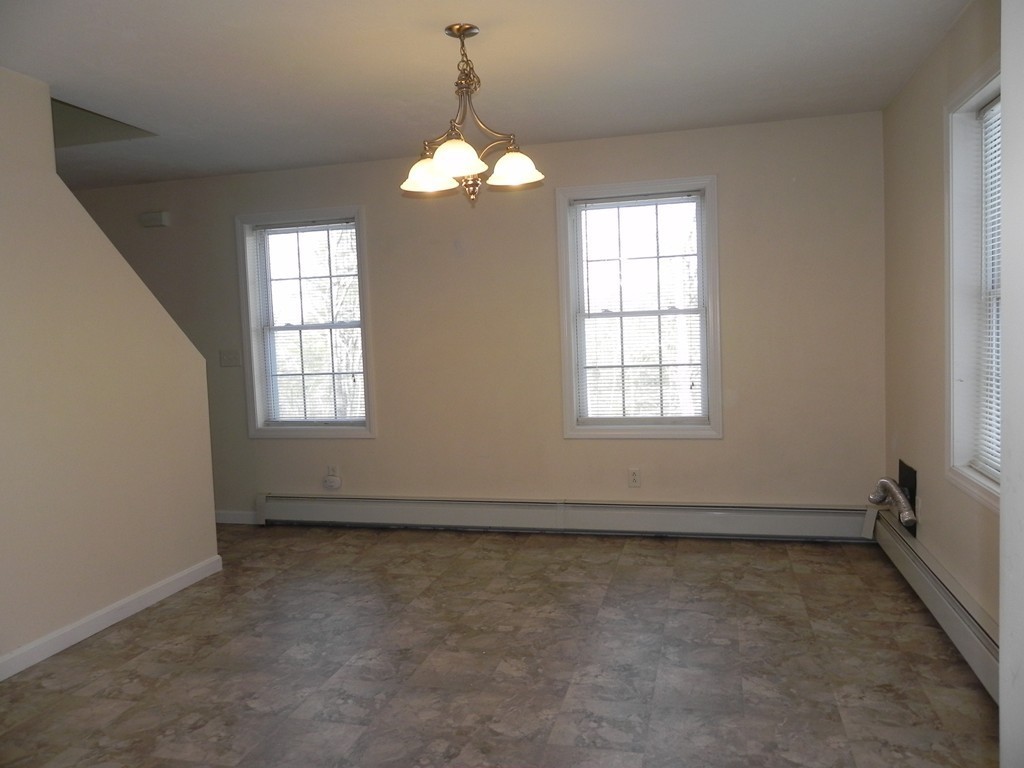 88 Brooks Road Athol, MA 01331 - Photo 8 of 30 an empty room with chandelier fan and windows