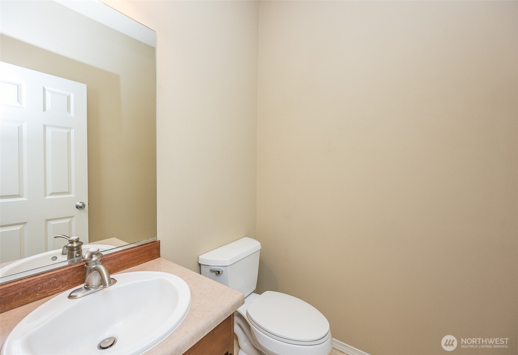5325 Military Road East, Unit B Tacoma, WA 98446 - Photo 12 of 27 a white toilet sitting next to a bathroom sink