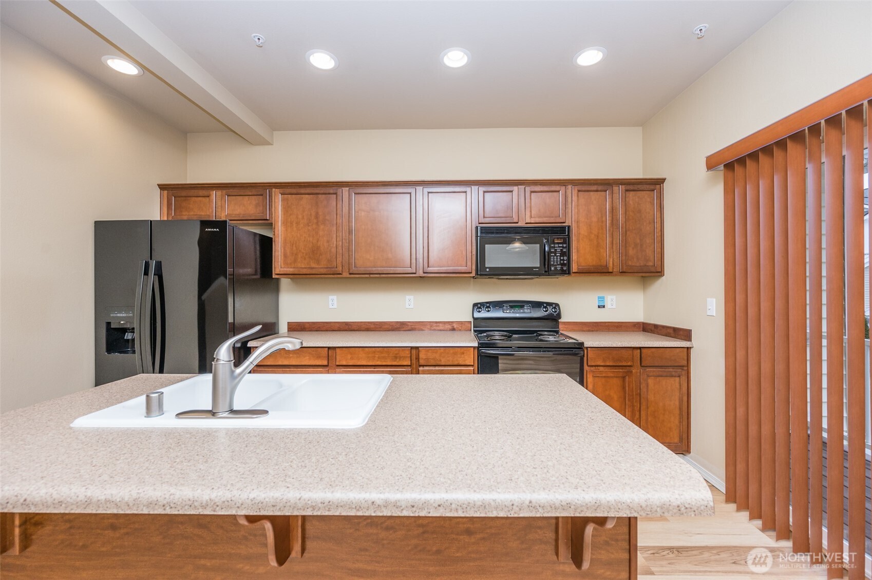 5325 Military Road East, Unit B Tacoma, WA 98446 - Photo 9 of 27 a kitchen with stainless steel appliances granite countertop a sink refrigerator and cabinets