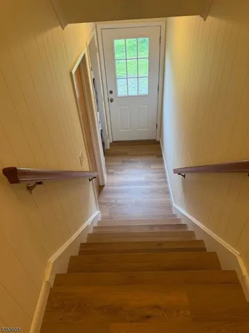 a view of a room with wooden floor and a window