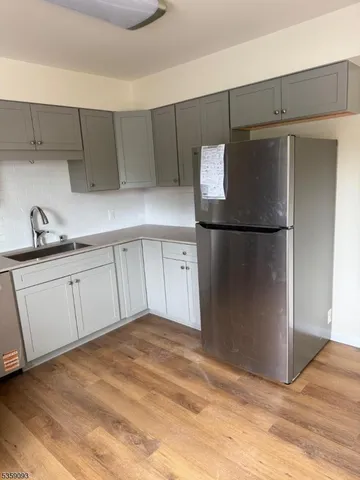 a kitchen with a refrigerator and a sink