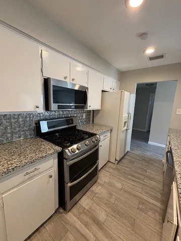 a kitchen with a stove and a refrigerator