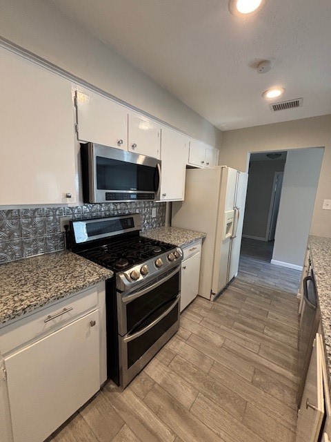 a kitchen with a stove and a refrigerator