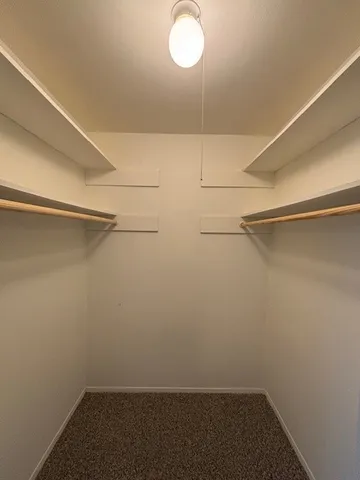 a bathroom with a granite countertop toilet sink and mirror