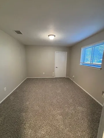 an empty room with a empty space and windows