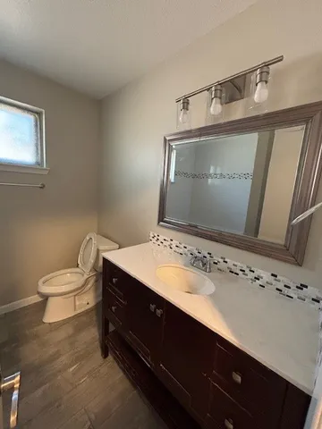 a bath tub sitting next to a white sink and vanity