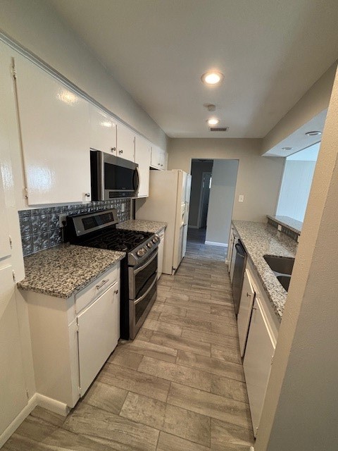 3303 Brooktree Lane Spring, TX 77380 - Photo 8 of 15 a kitchen with granite countertop a sink and steel appliances
