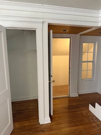 a view of wooden floor with kitchen