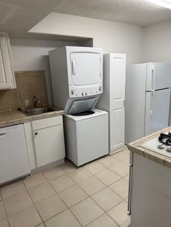 a white toilet sitting next to a bathroom sink