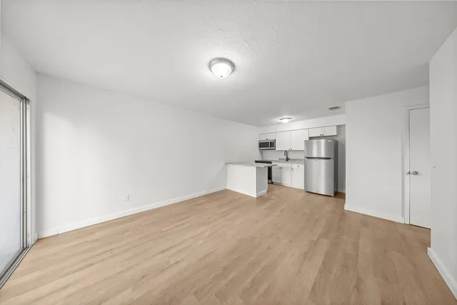 a view of a kitchen with a sink and wooden floor