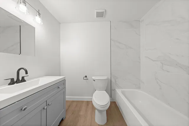 a bathroom with a sink a toilet and a bathtub