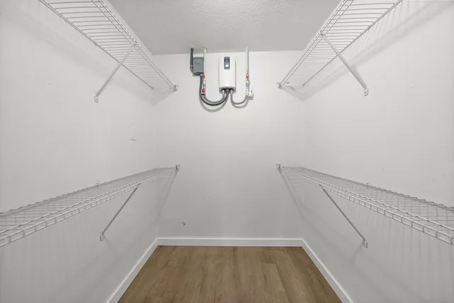 a view of walk in closet with empty racks