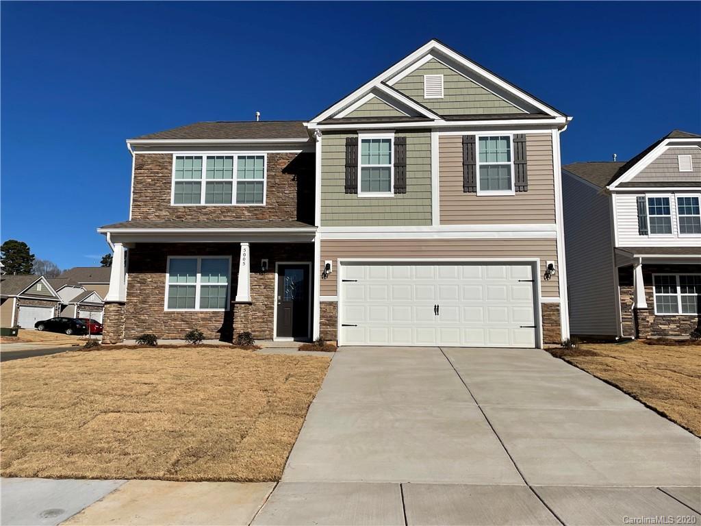 5005 Traynor Road, Unit 18 Charlotte, NC 28216 - Photo 1 of 35 a front view of a house with a yard