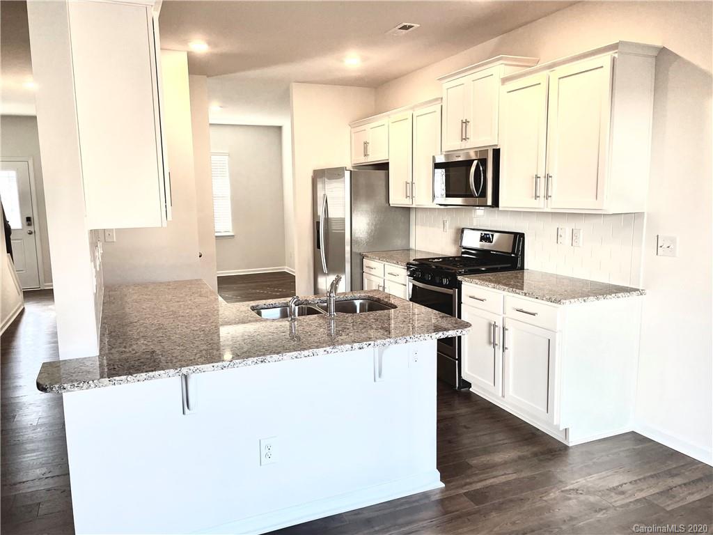 5005 Traynor Road, Unit 18 Charlotte, NC 28216 - Photo 11 of 35 a kitchen with stainless steel appliances granite countertop a sink stove and refrigerator