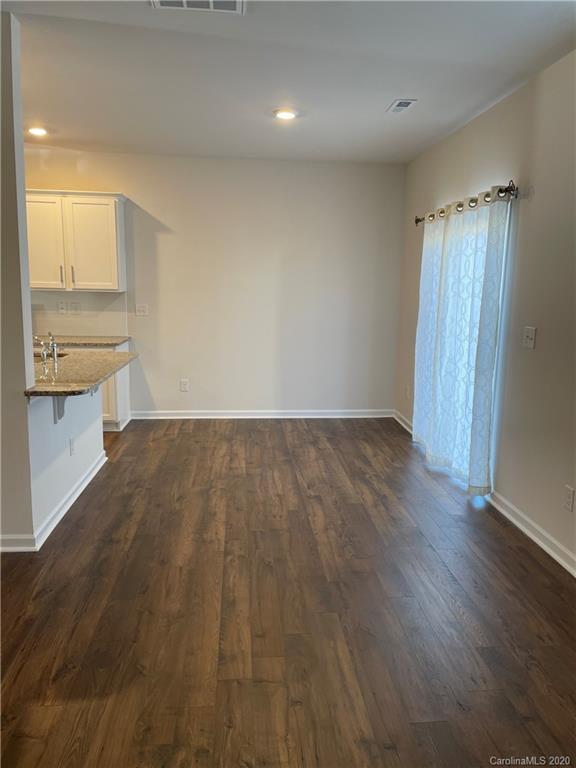 5005 Traynor Road, Unit 18 Charlotte, NC 28216 - Photo 15 of 35 wooden floor in an empty room with a window