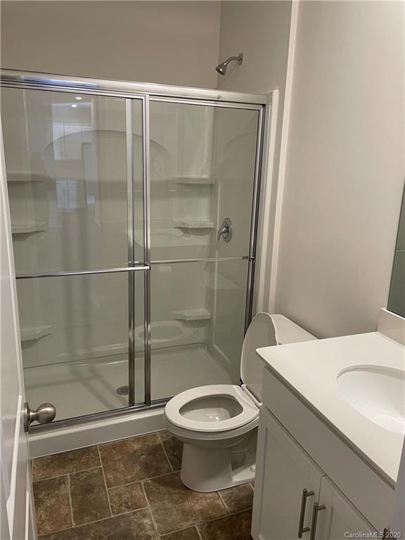5005 Traynor Road, Unit 18 Charlotte, NC 28216 - Photo 18 of 35 a white toilet sitting next to a shower