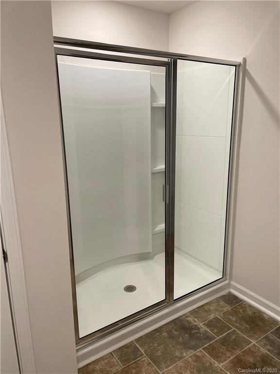 5005 Traynor Road, Unit 18 Charlotte, NC 28216 - Photo 23 of 35 a bathroom with a glass shower door