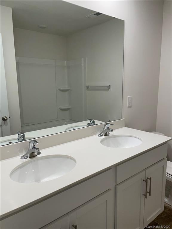 5005 Traynor Road, Unit 18 Charlotte, NC 28216 - Photo 28 of 35 a bathroom with a sink and a mirror