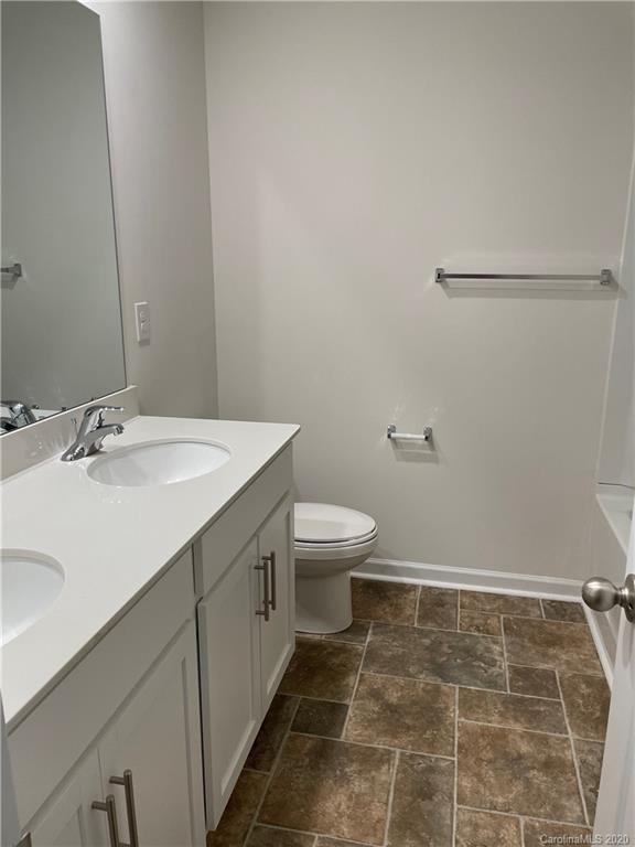 5005 Traynor Road, Unit 18 Charlotte, NC 28216 - Photo 29 of 35 a bathroom with a sink a toilet and a mirror