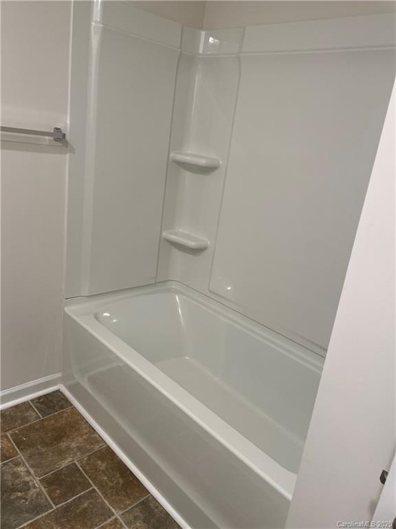 5005 Traynor Road, Unit 18 Charlotte, NC 28216 - Photo 30 of 35 a bathroom with a bathtub and a shower