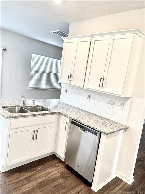 5005 Traynor Road, Unit 18 Charlotte, NC 28216 - Photo 10 of 35 a kitchen with stainless steel appliances granite countertop a sink and a stove