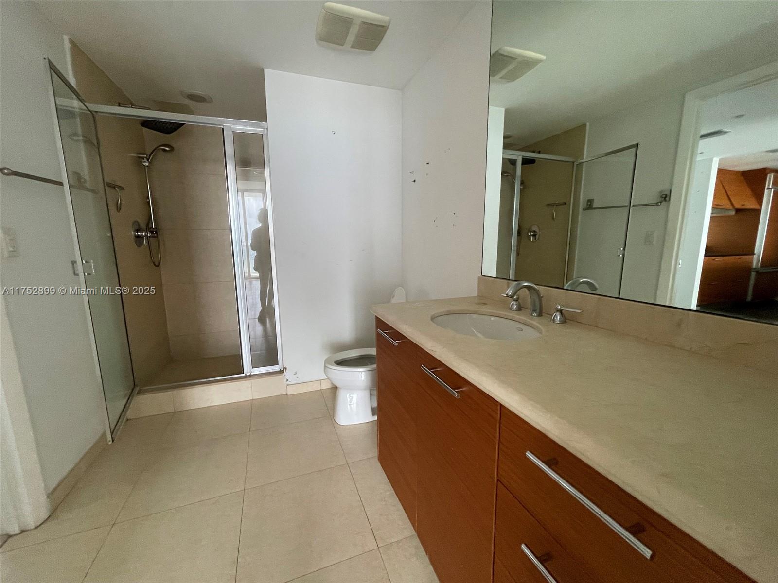 50 Biscayne Boulevard, Unit 4105 Miami, FL 33132 - Photo 13 of 41 a bathroom with a double vanity sink toilet and shower