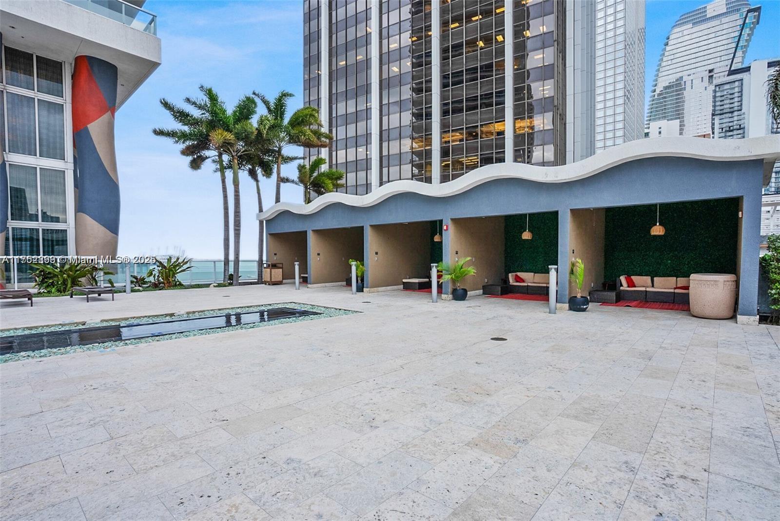 50 Biscayne Boulevard, Unit 4105 Miami, FL 33132 - Photo 20 of 41 a view of a house with potted plants and a large tree