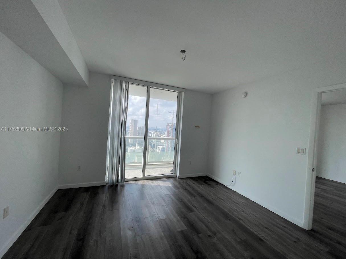 50 Biscayne Boulevard, Unit 4105 Miami, FL 33132 - Photo 37 of 41 wooden floor in an empty room with a window