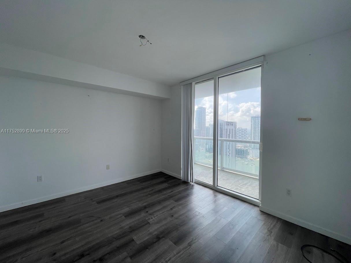 50 Biscayne Boulevard, Unit 4105 Miami, FL 33132 - Photo 38 of 41 a view of an empty room with wooden floor and a window