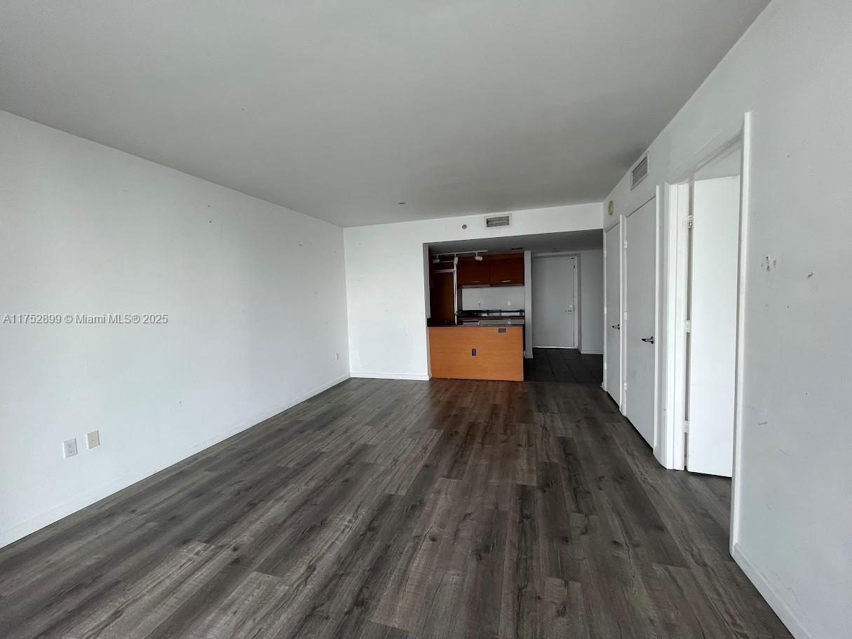 50 Biscayne Boulevard, Unit 4105 Miami, FL 33132 - Photo 39 of 41 a big room with wooden floor and stainless steel appliances