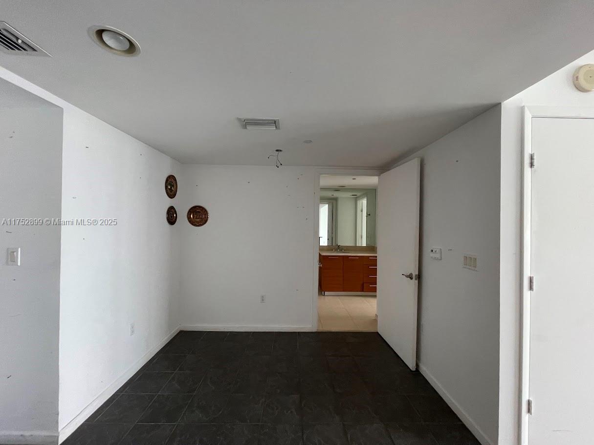 50 Biscayne Boulevard, Unit 4105 Miami, FL 33132 - Photo 41 of 41 a view of an empty room with wooden floor and a window