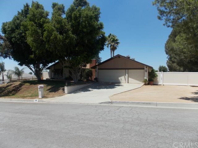 Gorgeous curb appeal with mature landscaping, roll up garage doors, and a newer Vinyl RV Gates!