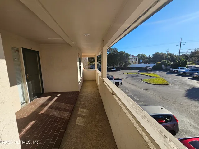 a view of a hallway view with wooden floor and staircase