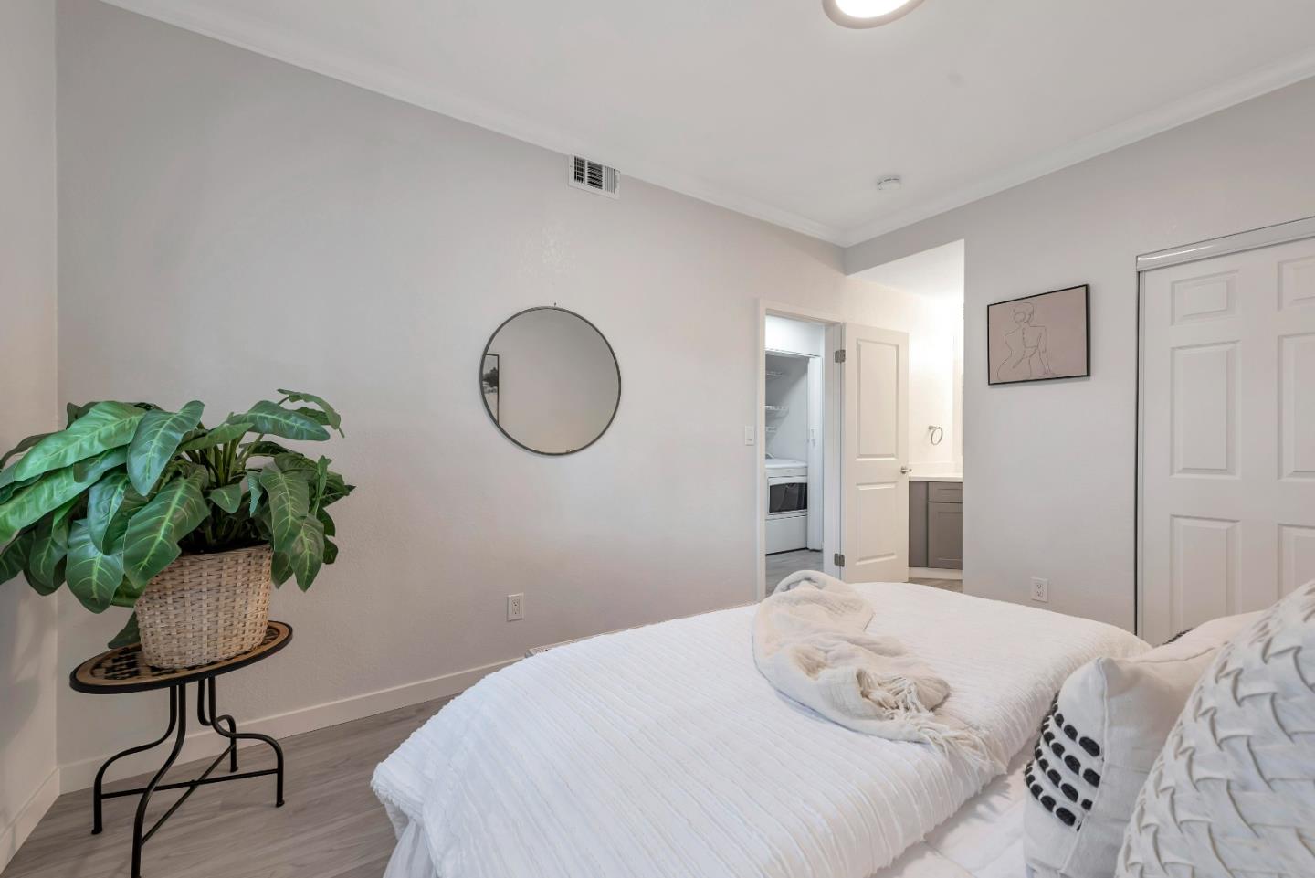 546 Shadowgraph Drive San Jose, CA 95110 - Photo 12 of 24 a bedroom with a bed potted plant and a mirror