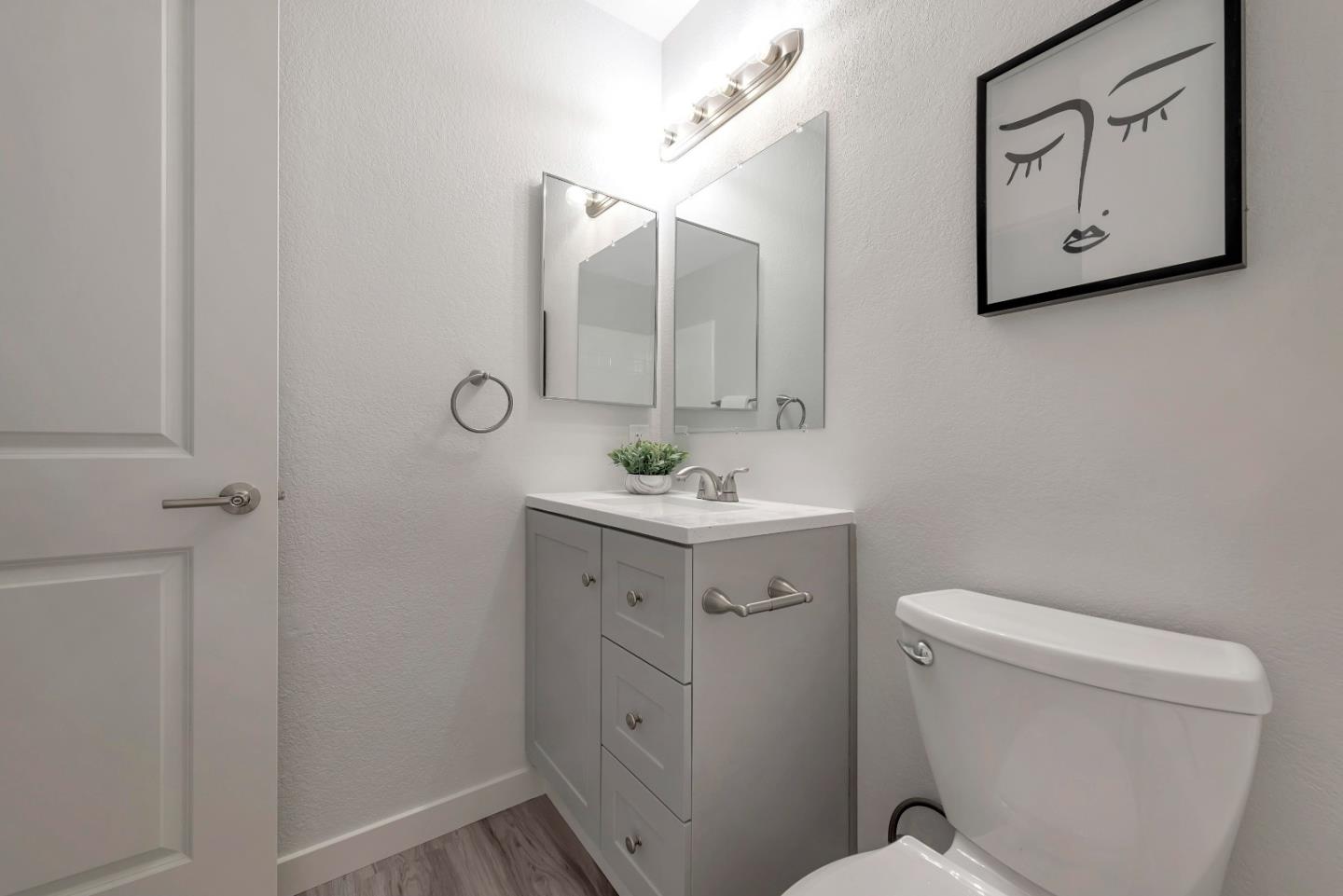 546 Shadowgraph Drive San Jose, CA 95110 - Photo 19 of 24 a bathroom with a toilet sink and mirror