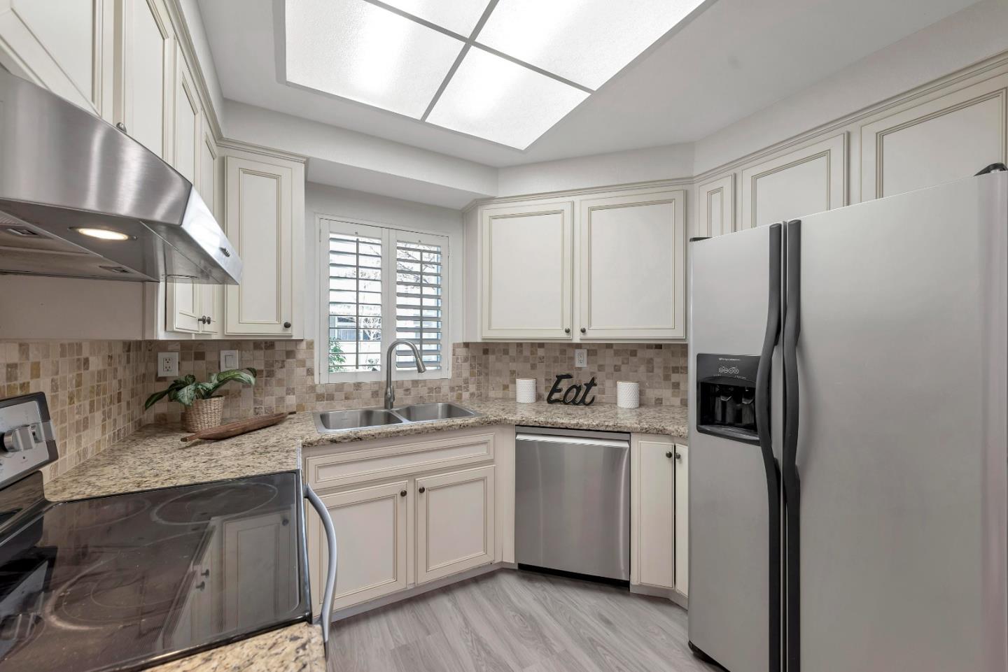 546 Shadowgraph Drive San Jose, CA 95110 - Photo 6 of 24 a kitchen with a sink cabinets stainless steel appliances and a window
