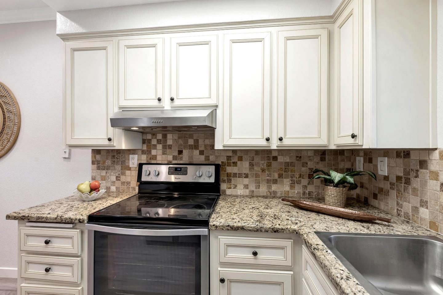 546 Shadowgraph Drive San Jose, CA 95110 - Photo 7 of 24 a kitchen with granite countertop a sink a stove and cabinets