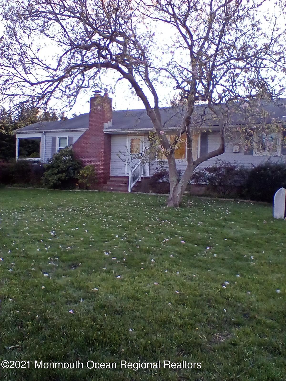 1623 Bailey Road Wall, NJ 07719 - Photo 1 of 14 a brick house with a large tree in front of a house