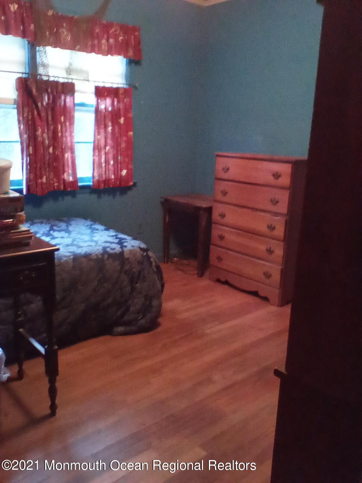 1623 Bailey Road Wall, NJ 07719 - Photo 14 of 14 a bedroom with a bed and a dresser