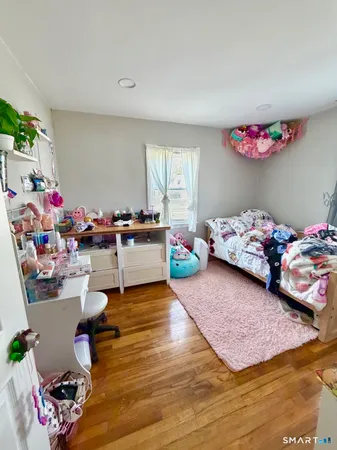 a living room with furniture and a mirror