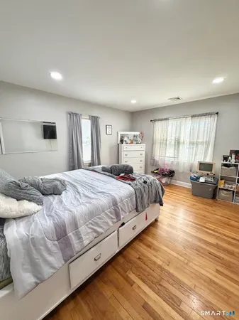 a bedroom with furniture and a window