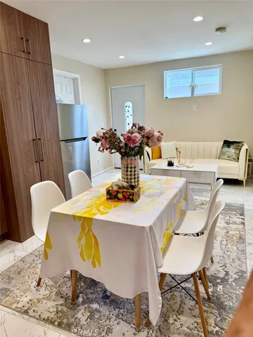 a kitchen with granite countertop a refrigerator stove microwave and cabinets